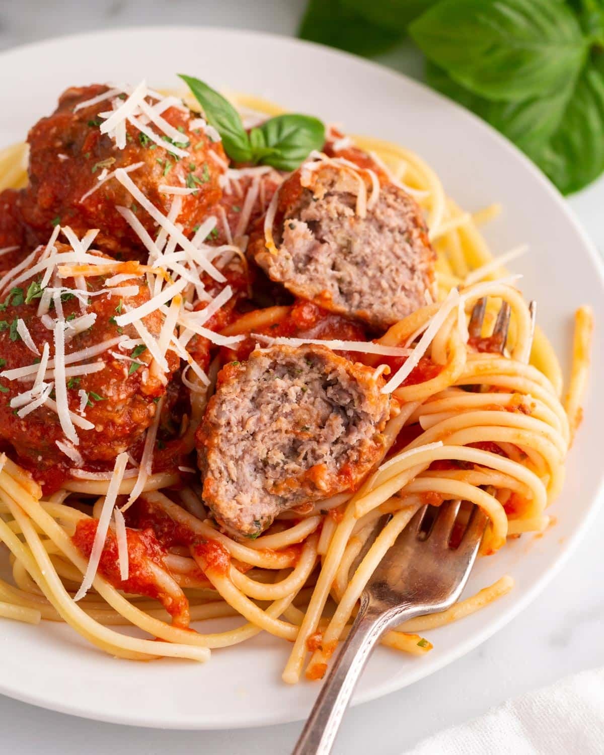 a plate of Italian meatballs on a plate with pasta and sauce