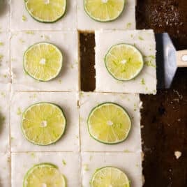 overhead view of key lime sheet cake with limes on top