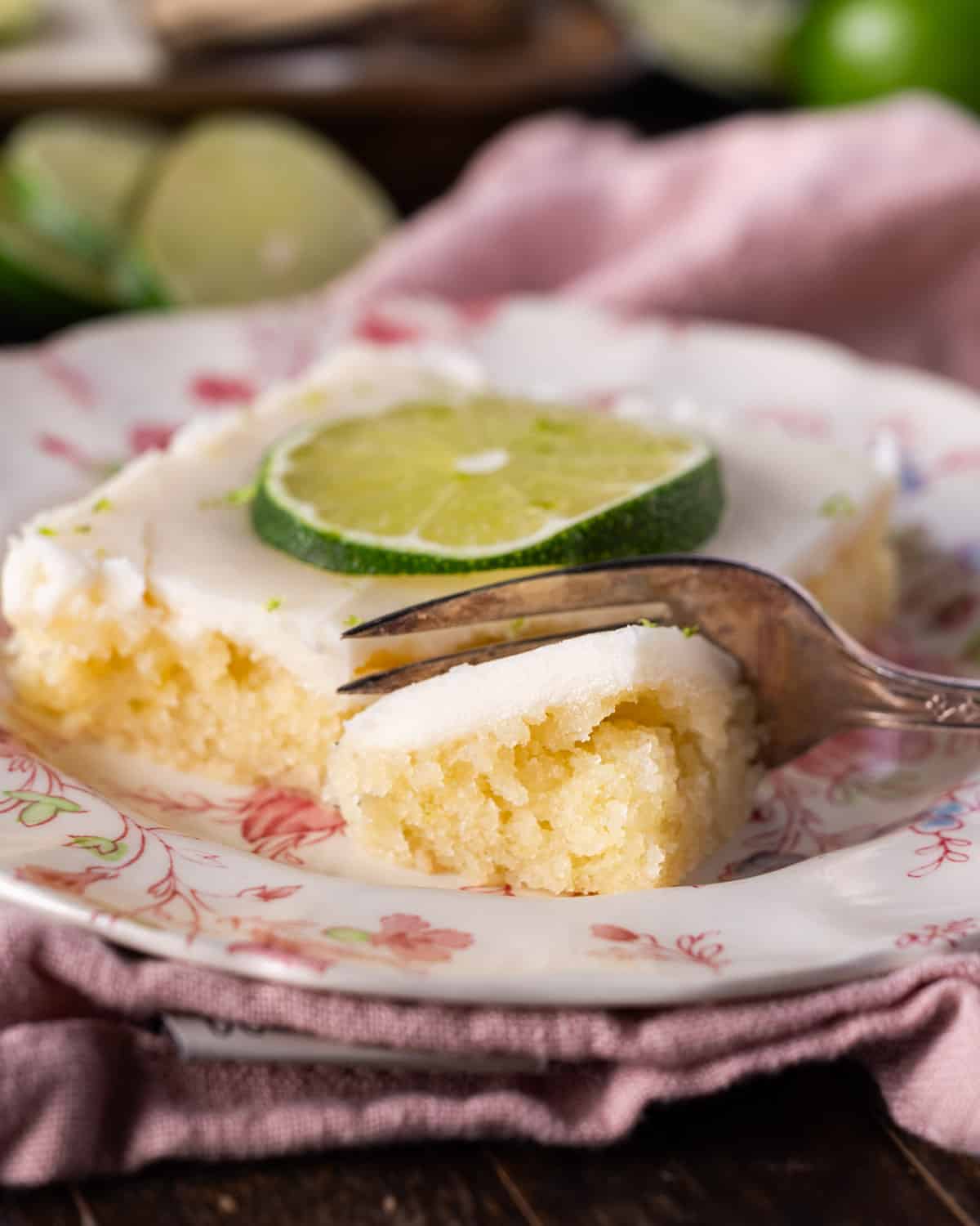 a piece of key lime cake on a plate with a fork