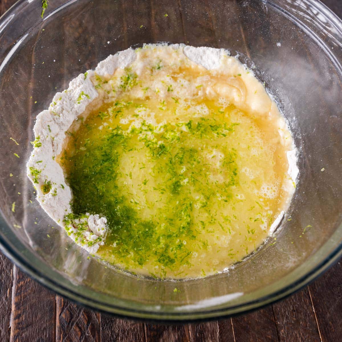 dry ingredients with wet ingredients on top for key lime cake