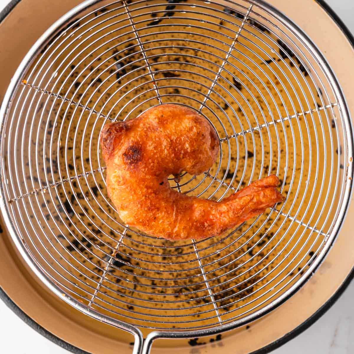 a fried shrimp on a strainer