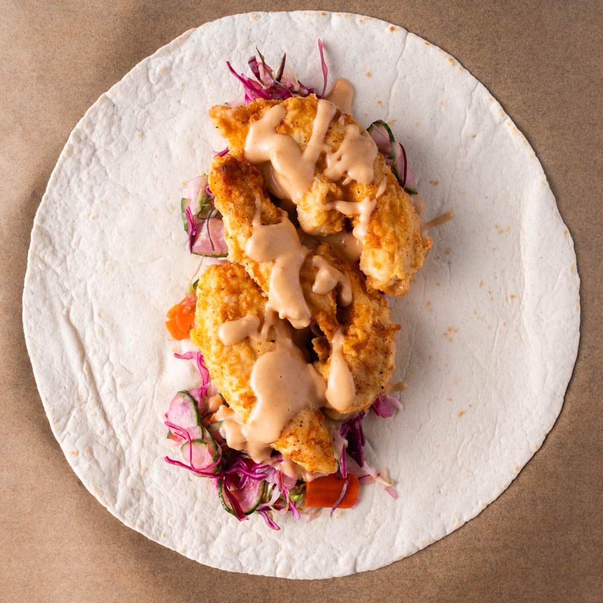 chipotle honey mustard sauce over chicken and slaw in a wrap