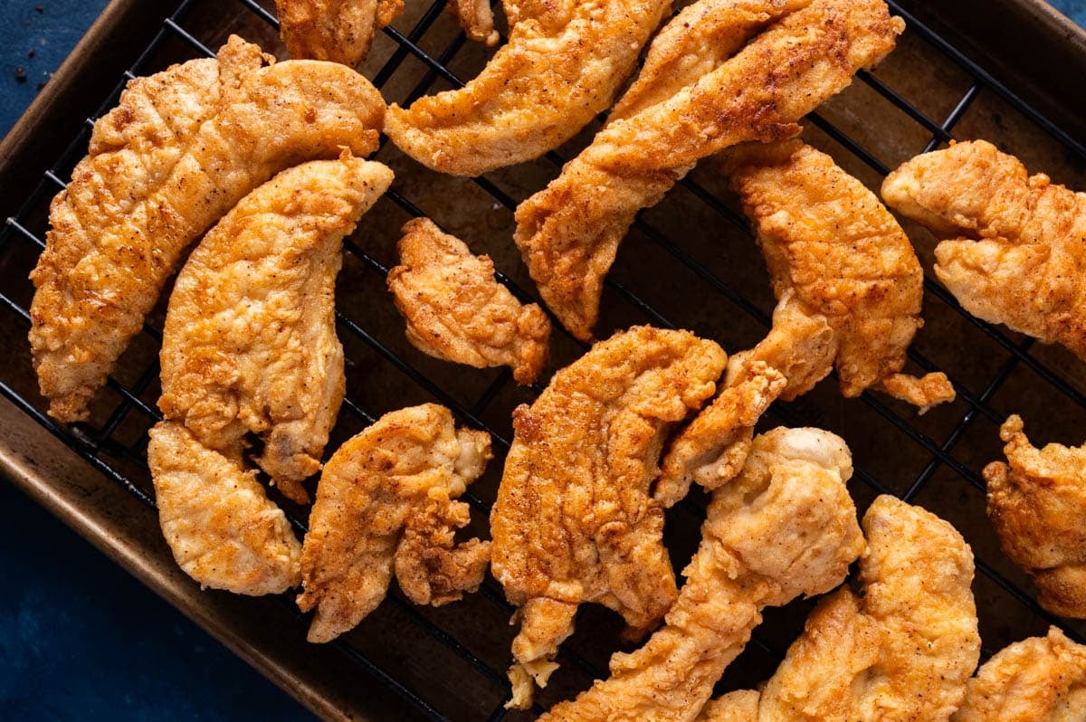fried chicken tenderloins on a wire rack