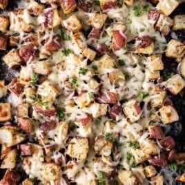 overhead view of roasted red potatoes with melted cheese