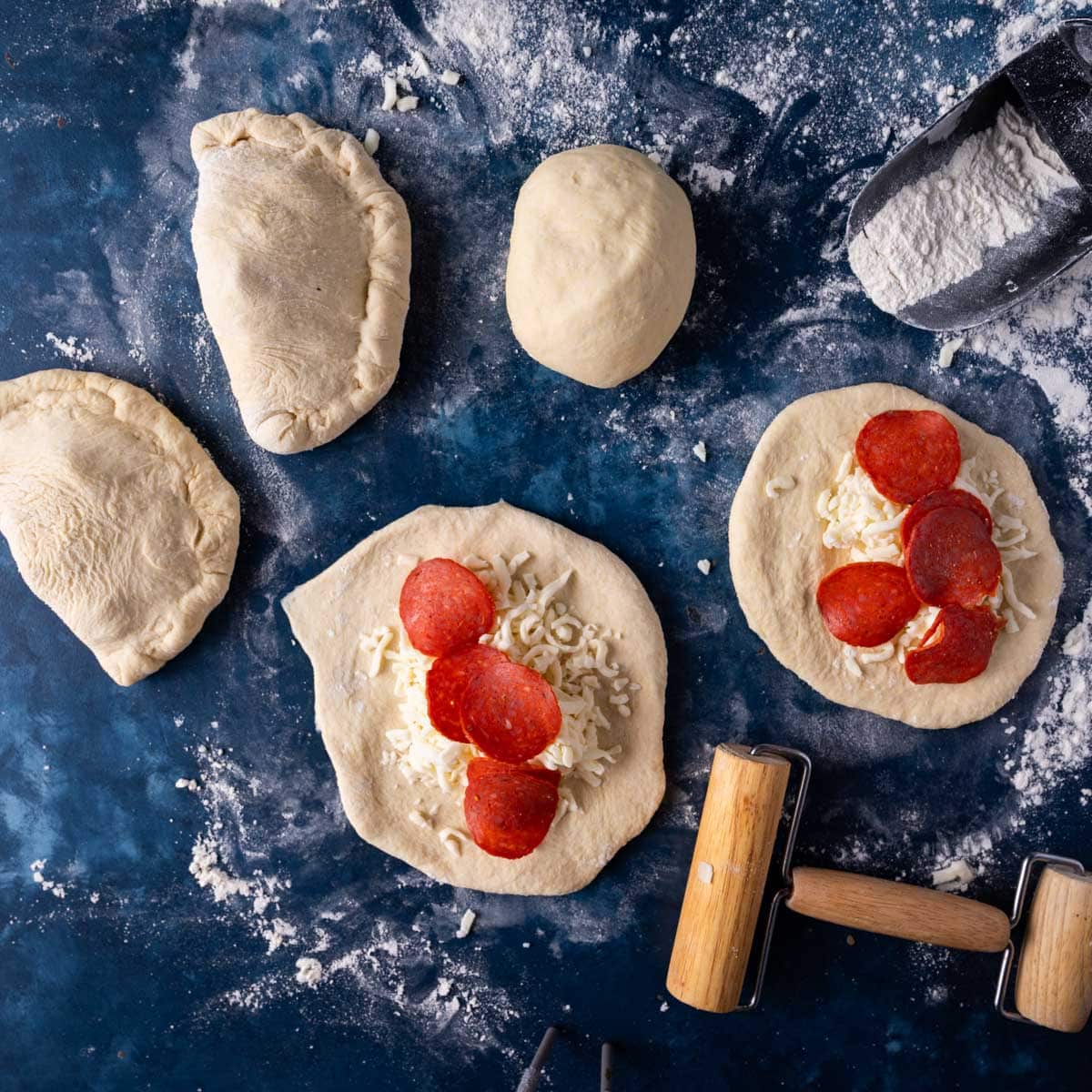 unbaked pepperoni calzones on a table