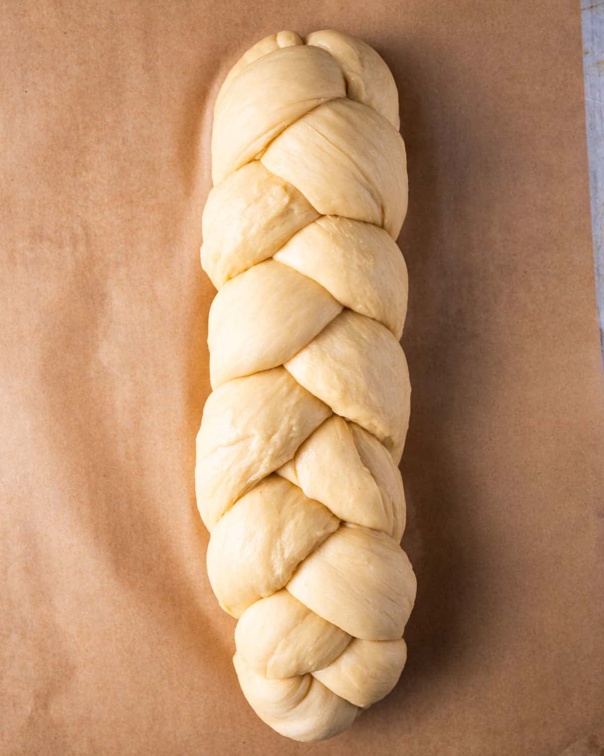 unbaked braided bread on a baking sheet