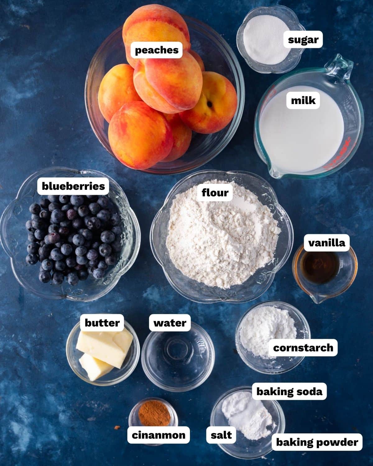 ingredients for peach blueberry cake on a table