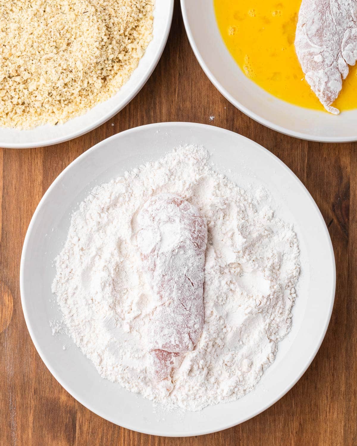 chicken tender on flour on a plate