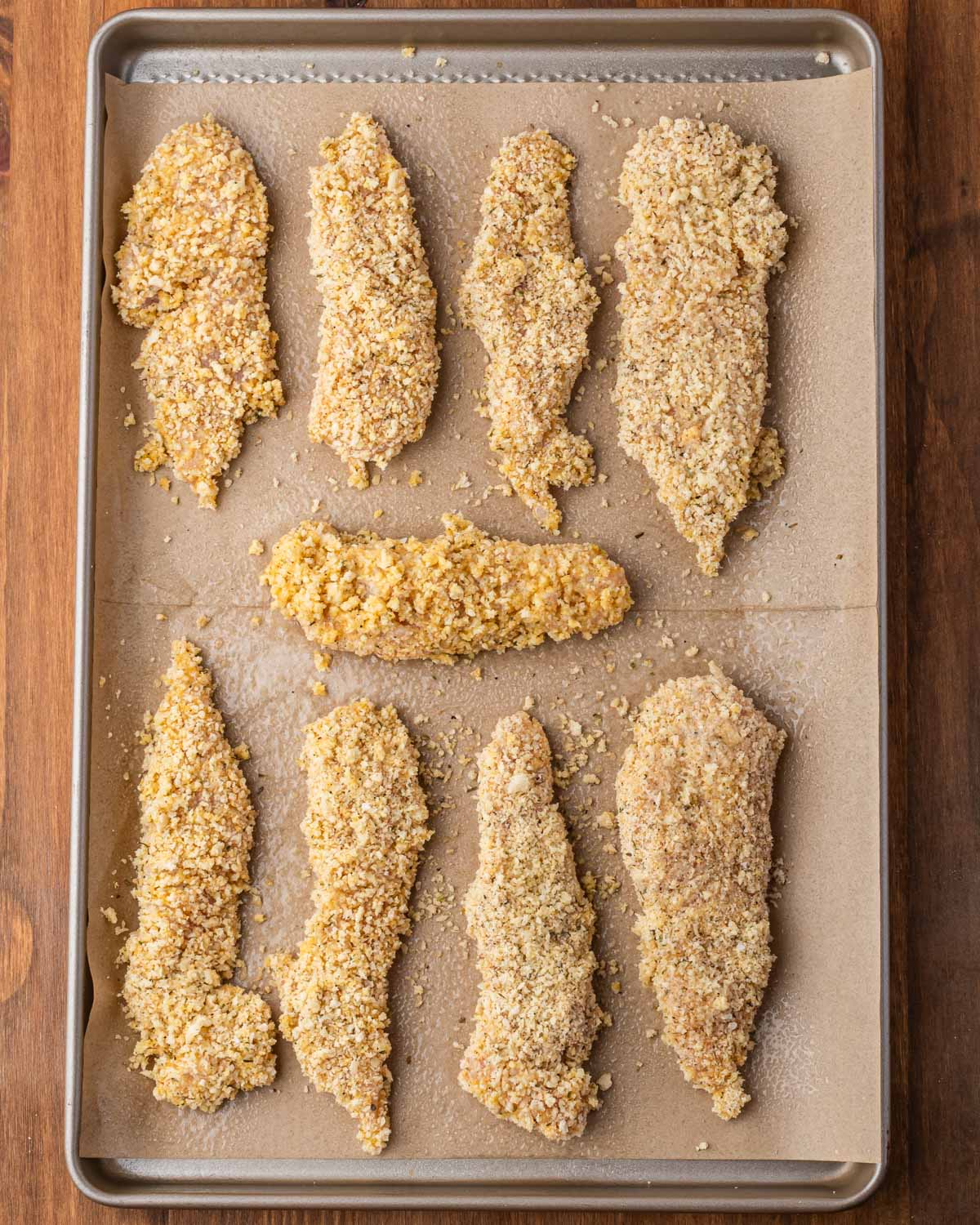 unbaked chicken tenders on a baking sheet