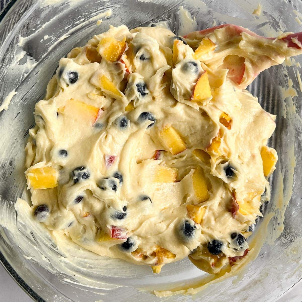 blueberry peach cake batter in a bowl
