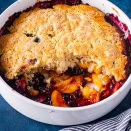 peach blueberry cobbler in a round pan