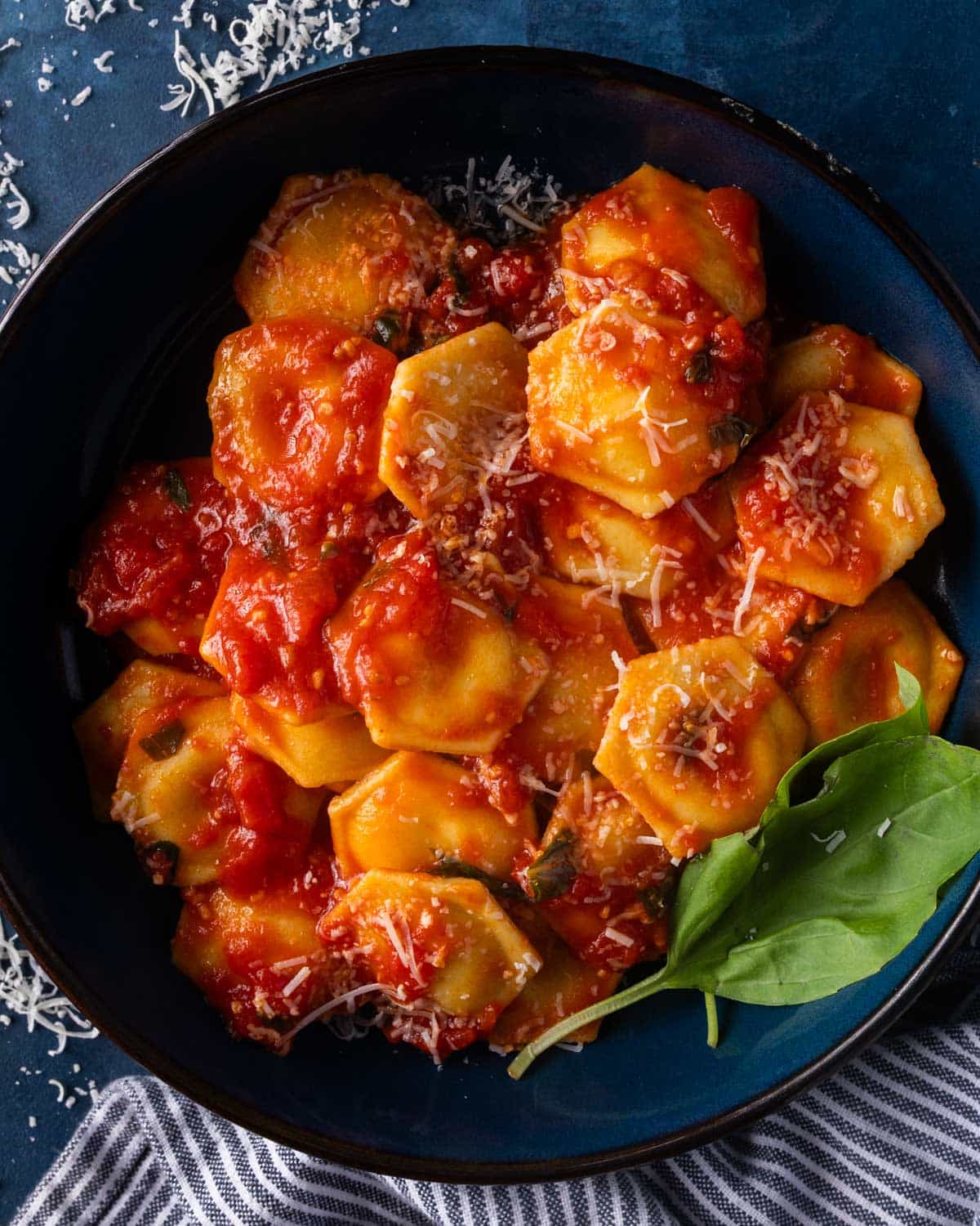 a bowl of ravioli with fresh tomato sauce