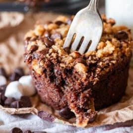 a chocolate muffin on a table with a fork