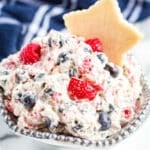 triple berry fruit dip with a cookie in a bowl