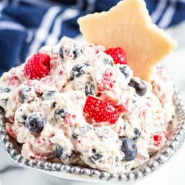 triple berry fruit dip with a cookie in a bowl