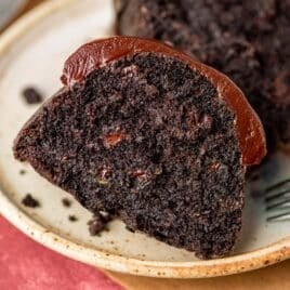 a slice of chocolate zucchini cake on a plate