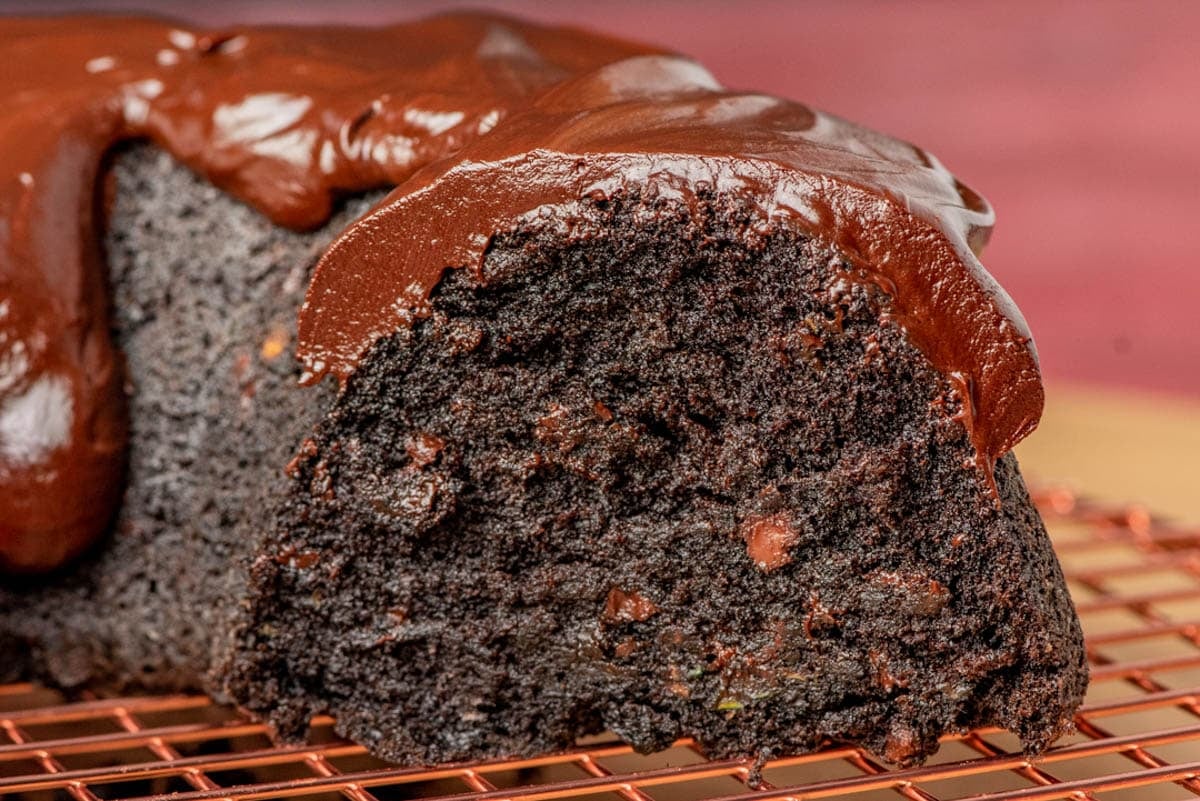 closeup of a chocolate zucchini bundt cake on a wire rack