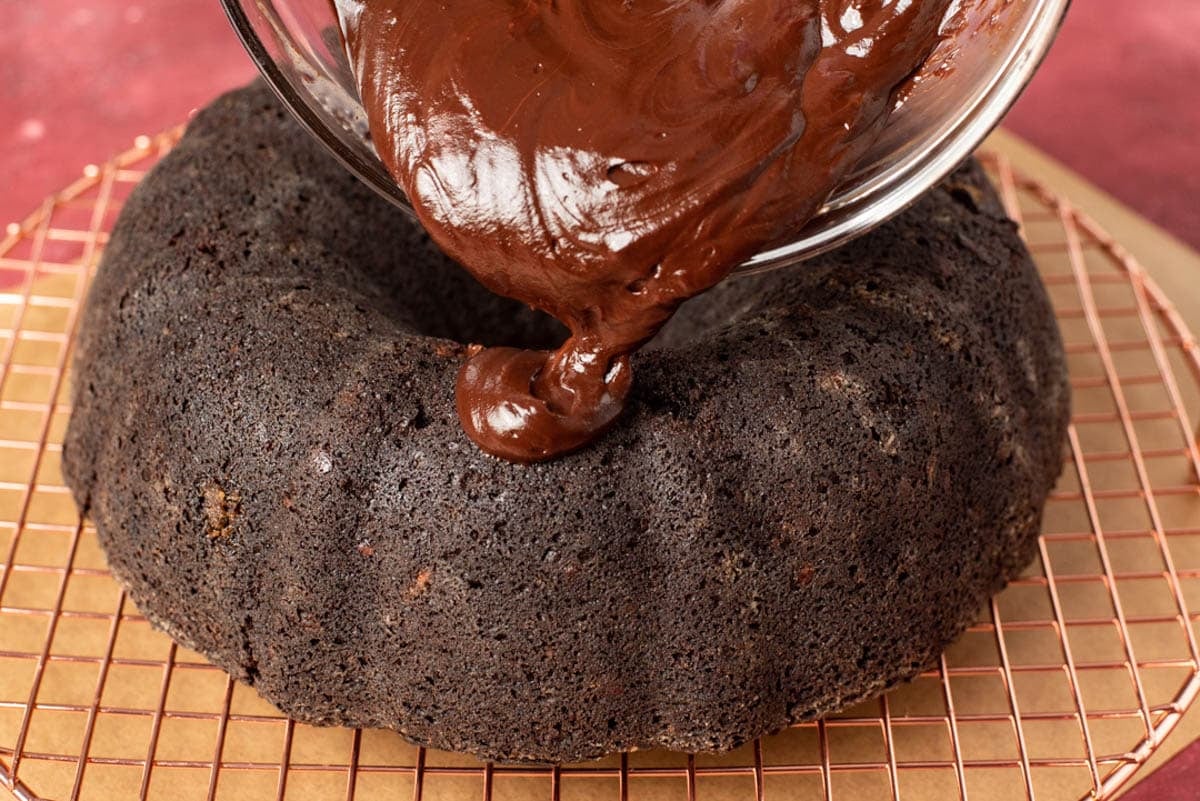 chocolate ganache pouring on a zucchini bundt cake