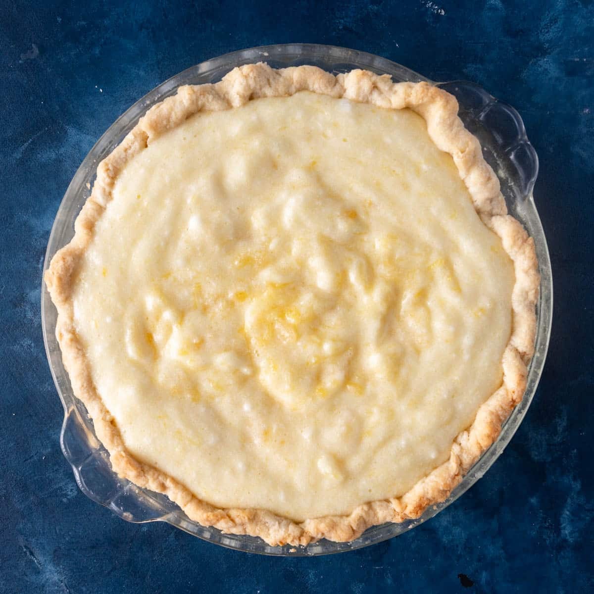 overhead view of a pie shell with pineapple cream filling