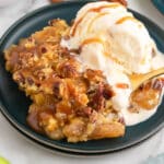 caramel apple dump cake on a plate with ice cream