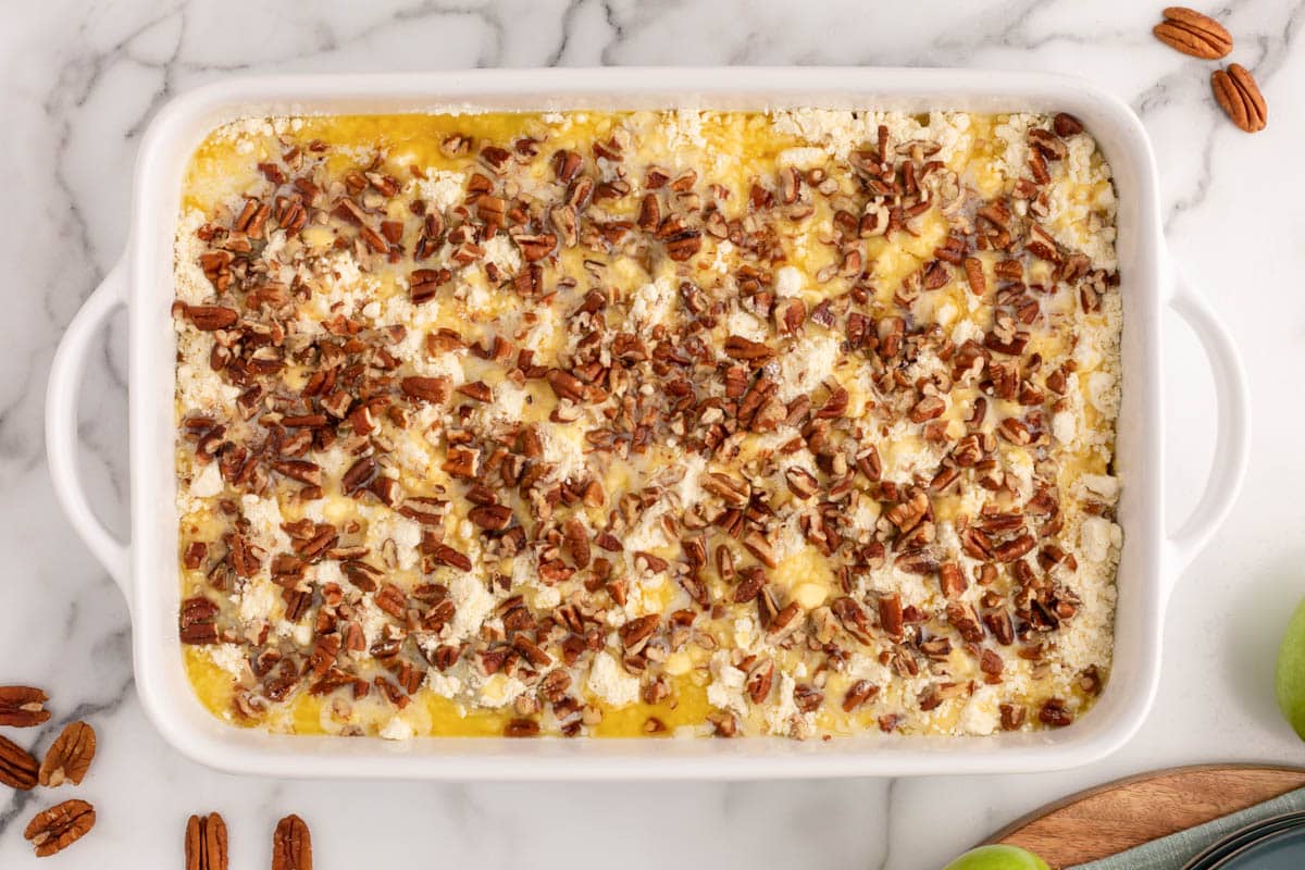 unbaked cake with pecans on top