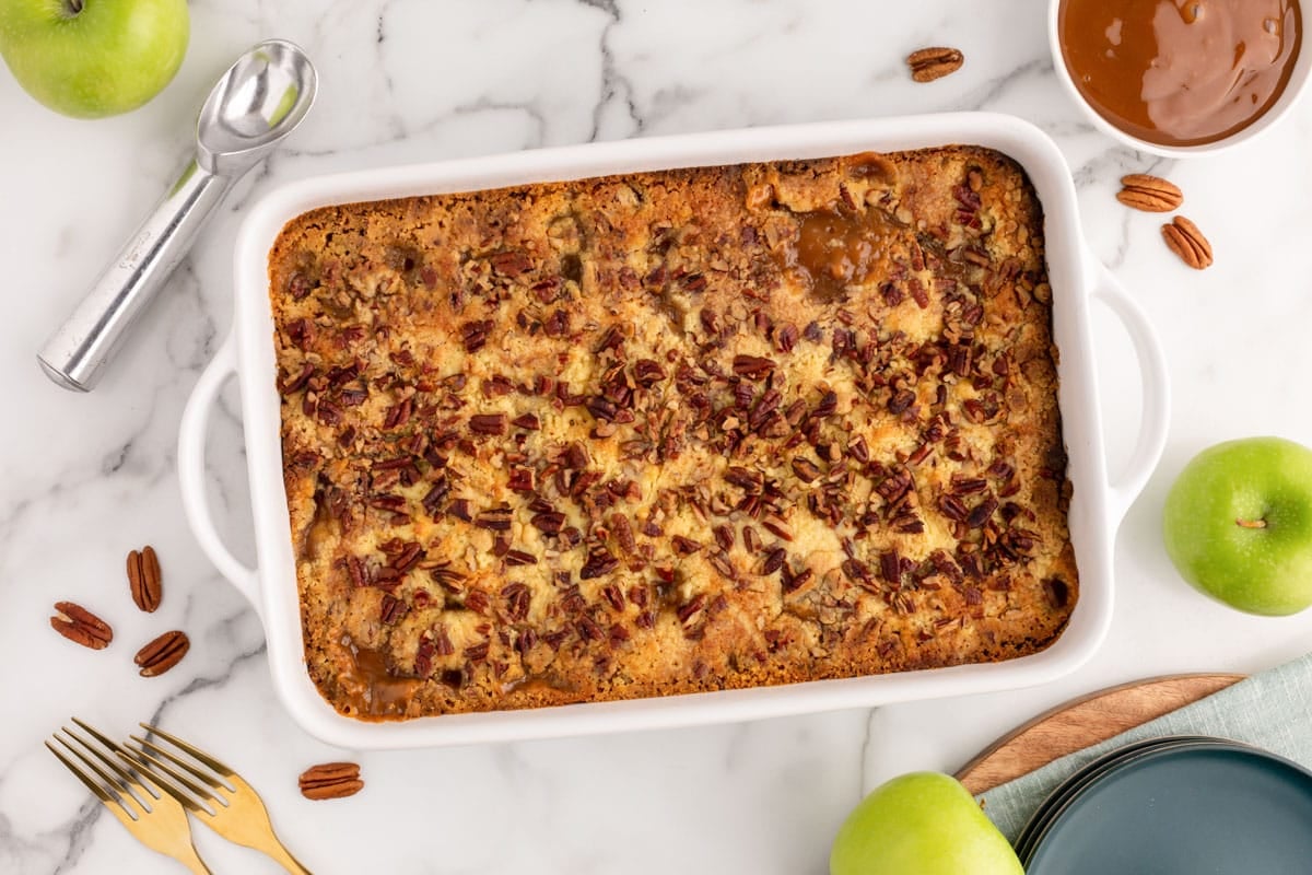 overhead view of a apple dump cake with caramel in a baking pan