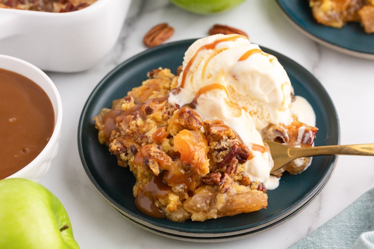caramel apple dump cake with ice cream and caramel sauce