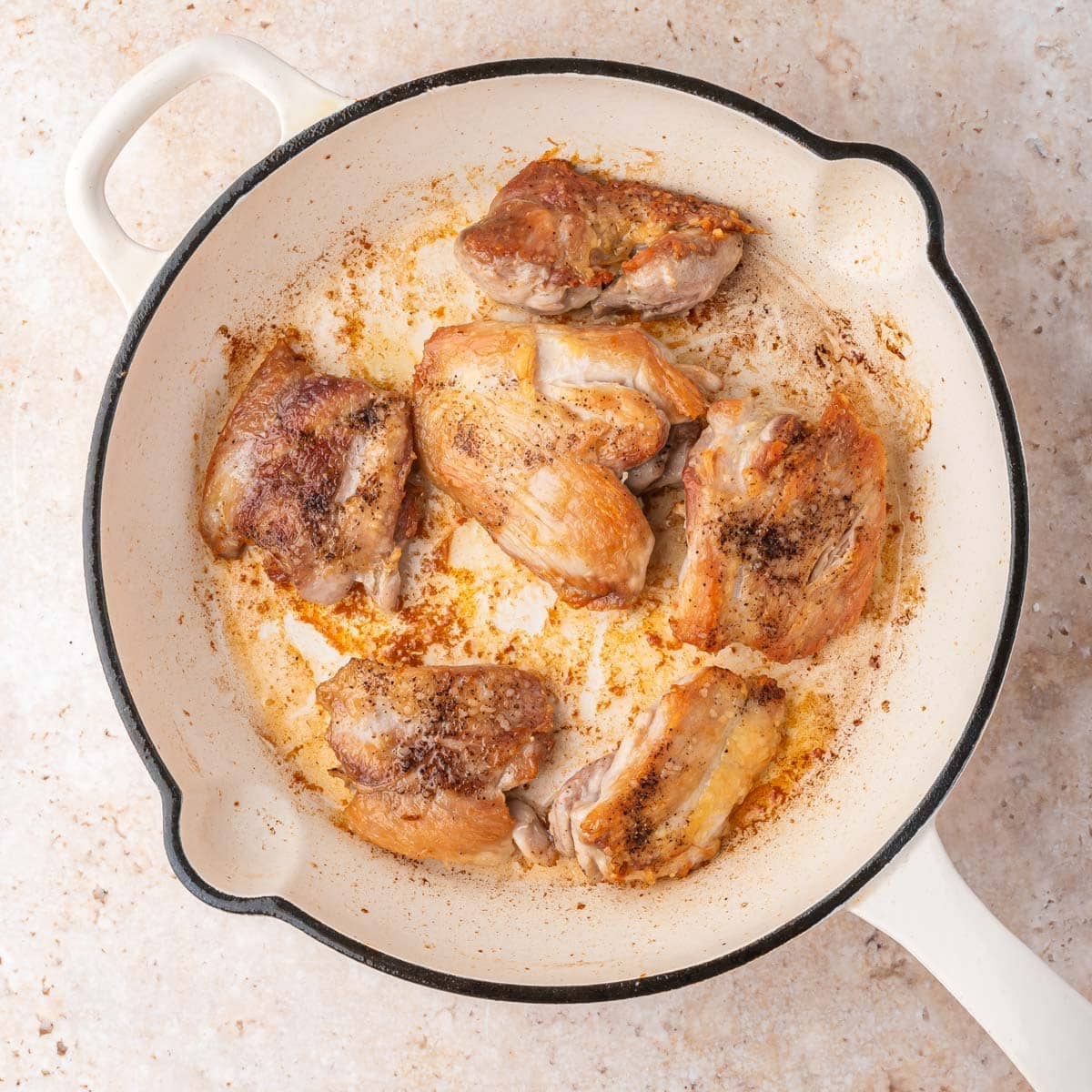 golden brown chicken thighs in a skillet