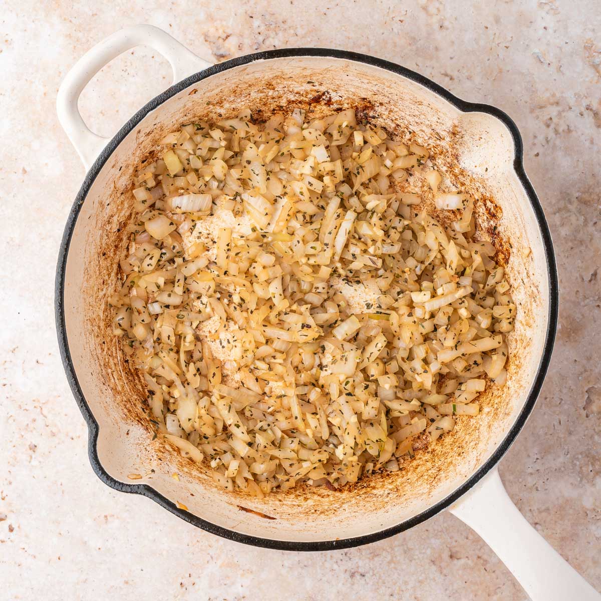 sautéed onions and seasoning in a skillet