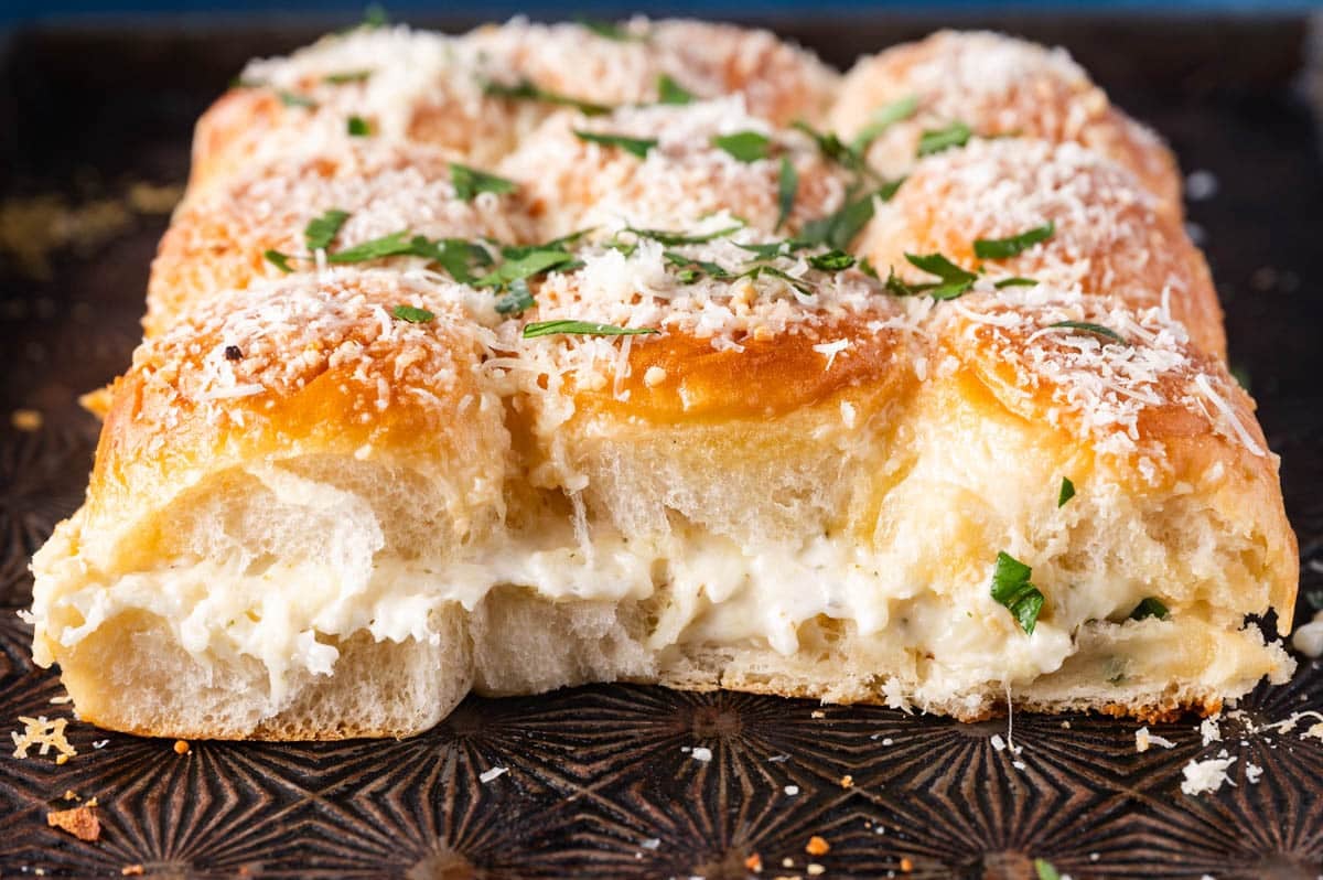 garlic bread hawaiian rolls on a pan