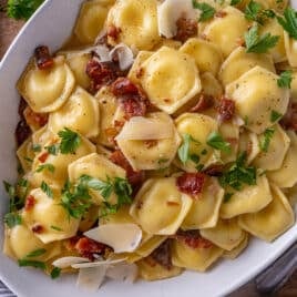 ravioli carbonara with fresh parmesan and parsley on a plate
