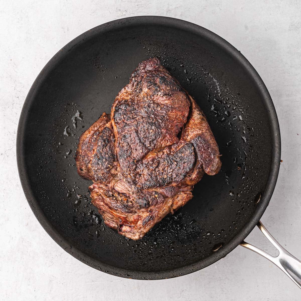 browned chuck roast in a skillet