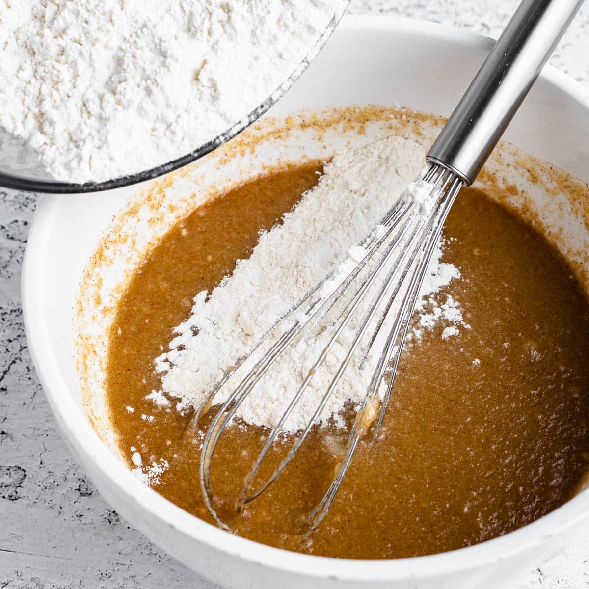 flour over wet ingredients in a bowl