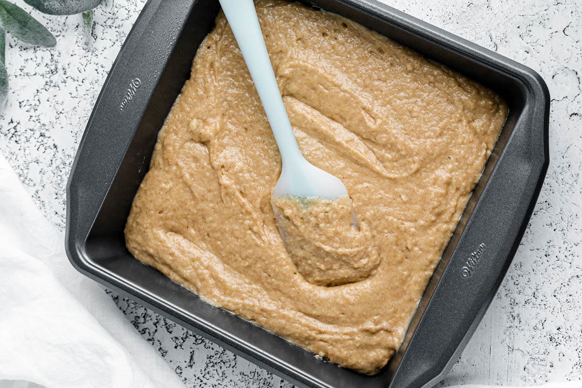 unbaked apple cider cake in a pan