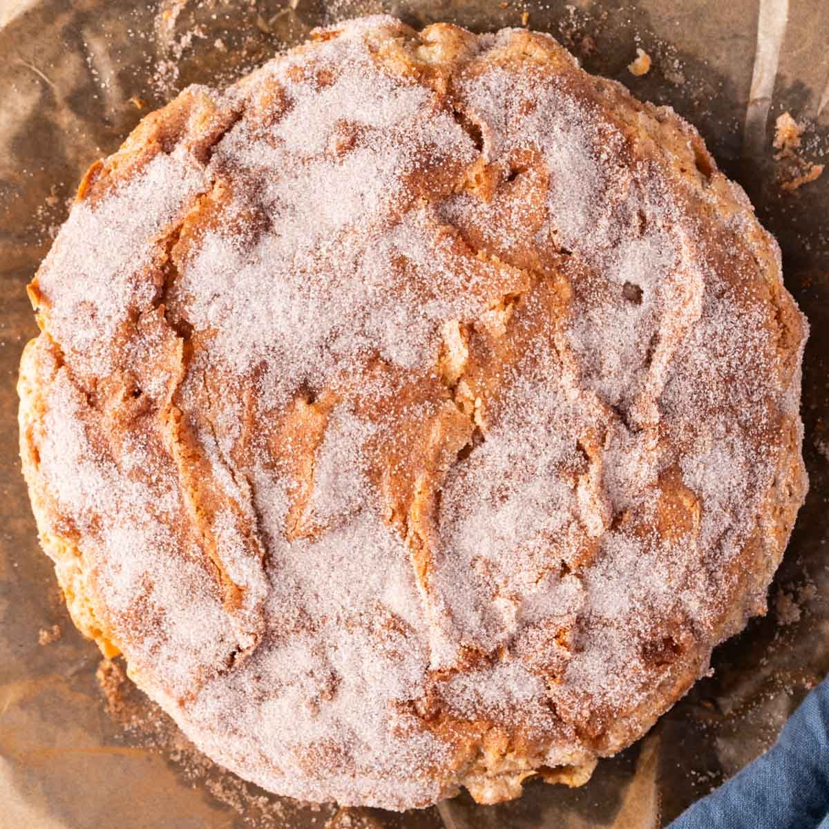 overhead view of apple cinnamon cake with cinnamon sugar sprinkled on top
