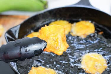 tongs holding a fried plantains