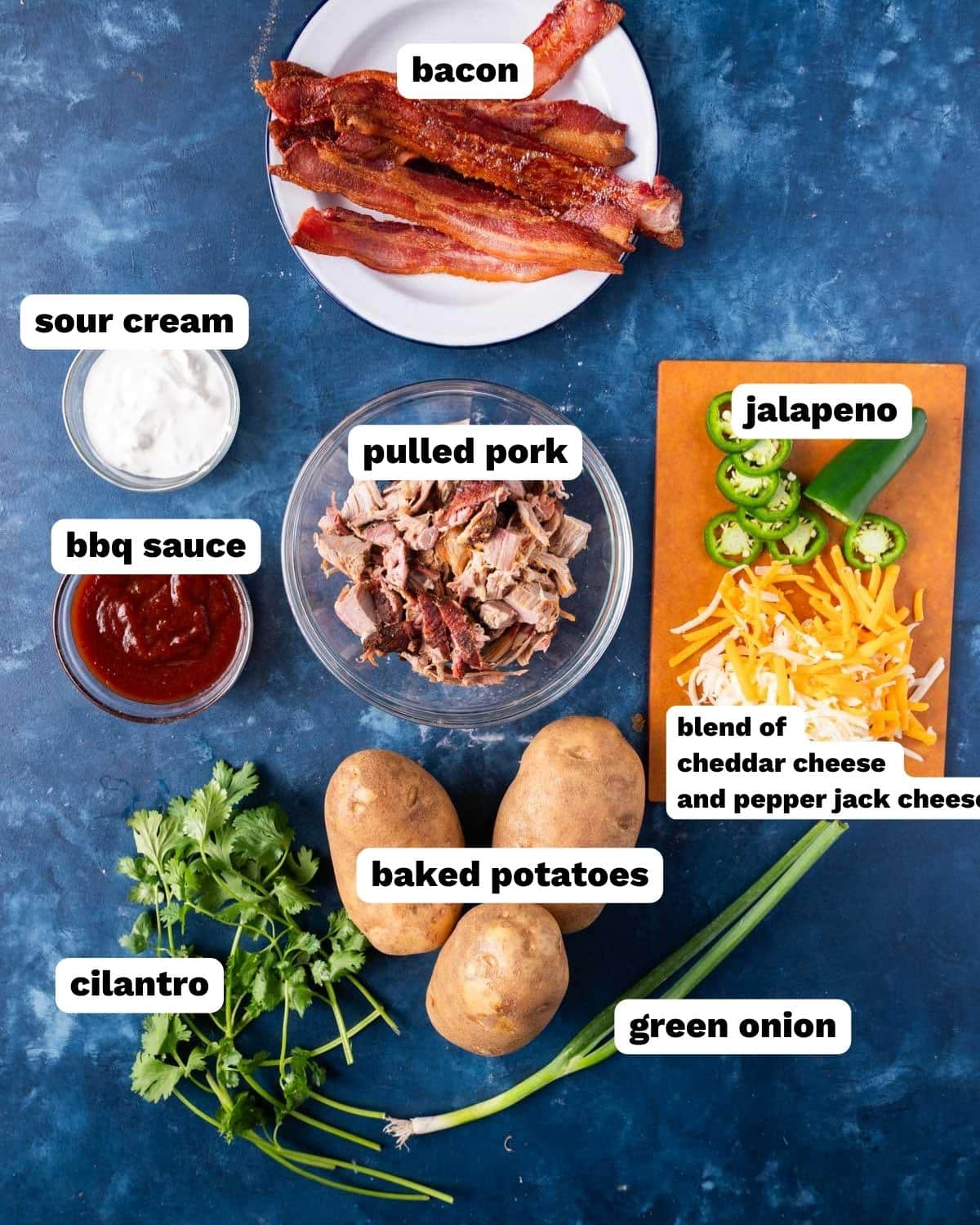 pulled pork baked potatoes ingredients on a table