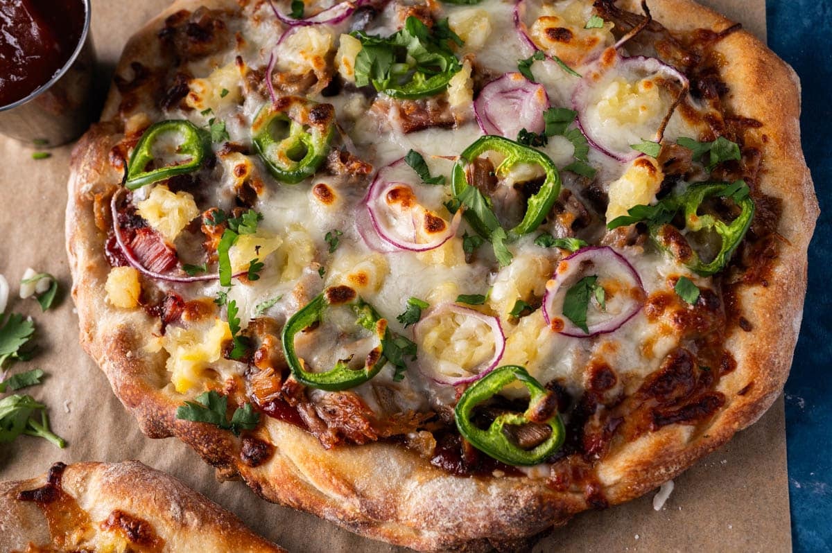 closeup of pulled pork pizza on a table