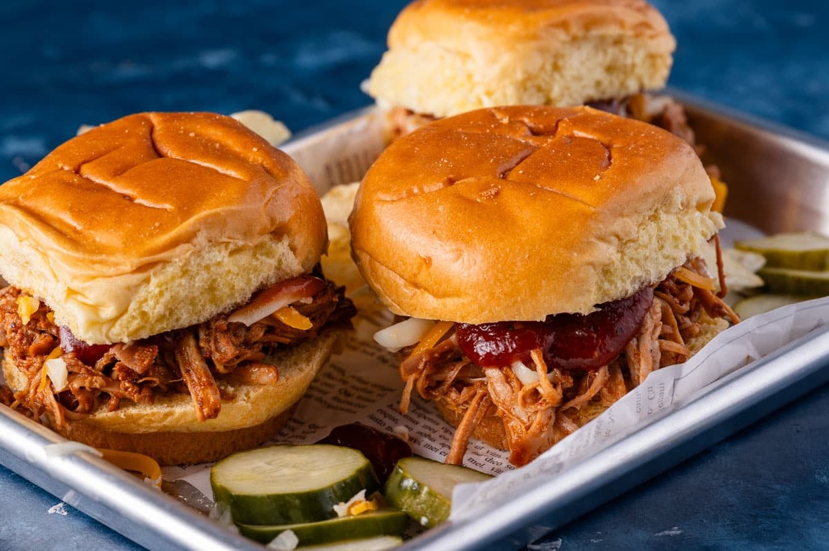 three bbq pulled pork sliders on a tray