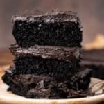 black chocolate cake stacked on a plate