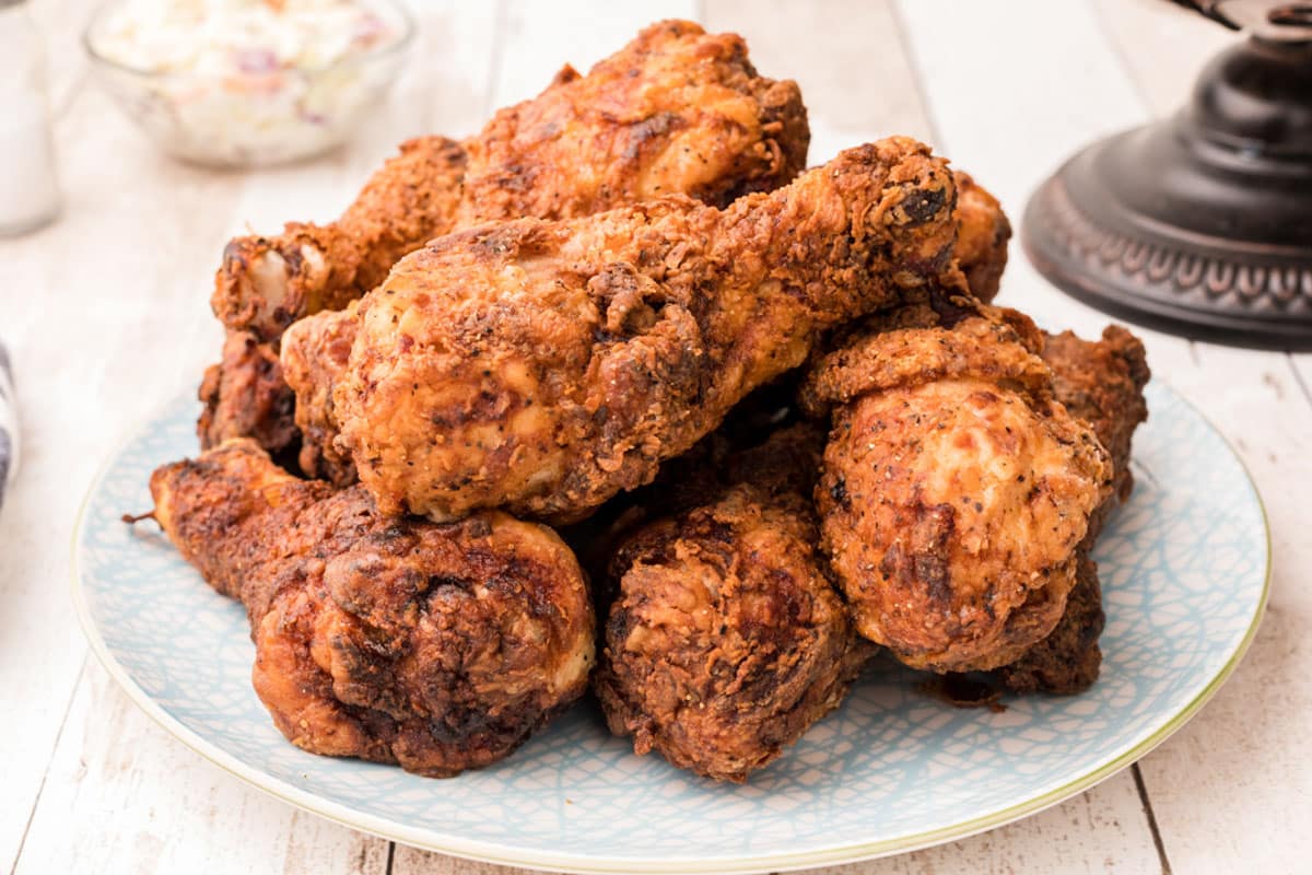 a plate of chicken fried drumsticks