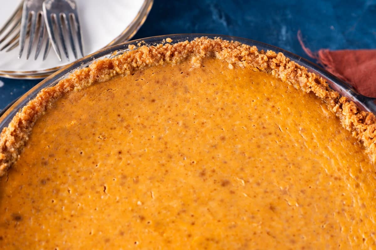 closeup of pumpkin pie with graham cracker crust