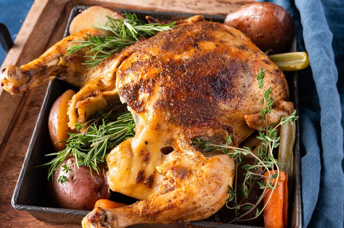 a whole chicken with browned skin on a table