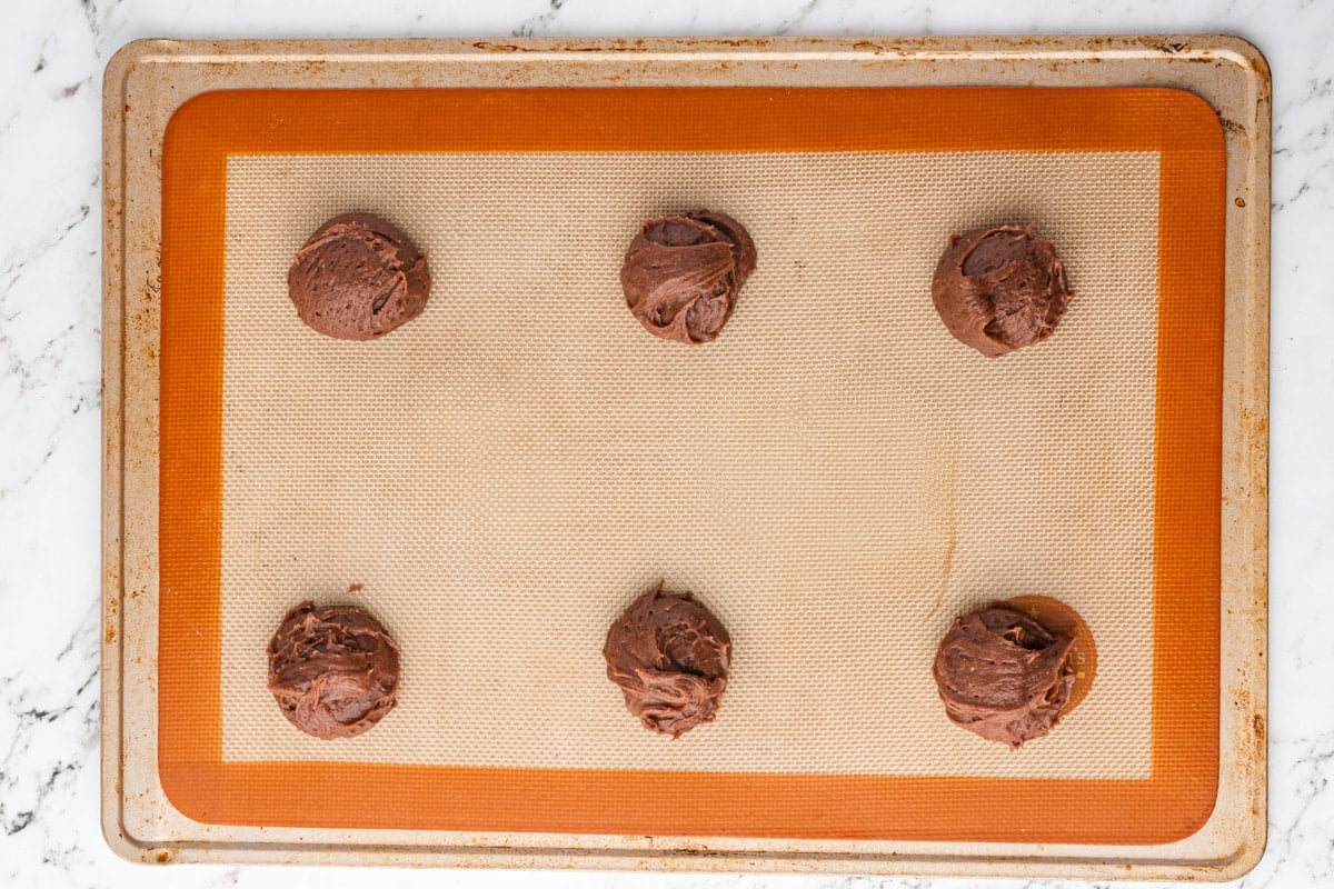 unbaked chocolate cookies on a baking sheet