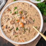 a bowl of wild rice mushroom soup on a table