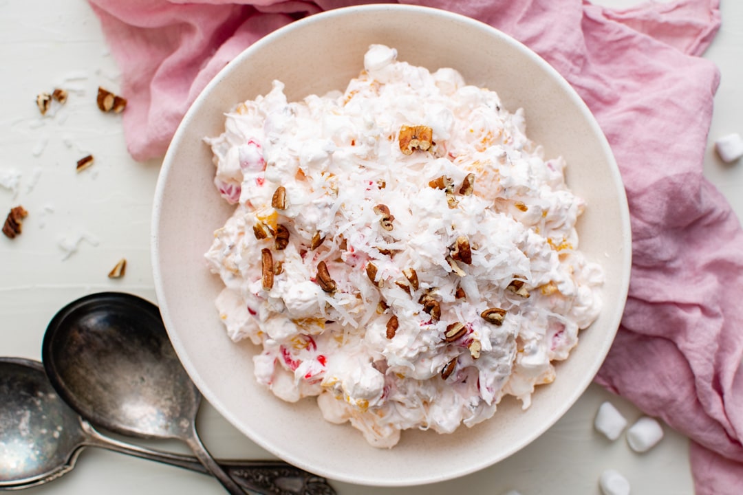 overhead view of a bowl of ambrosia with coconut and pecans