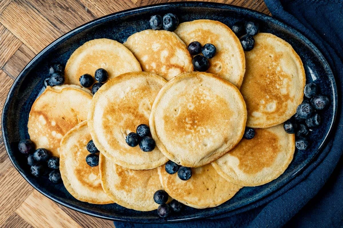 a plate of homemade pancakes and blueberries