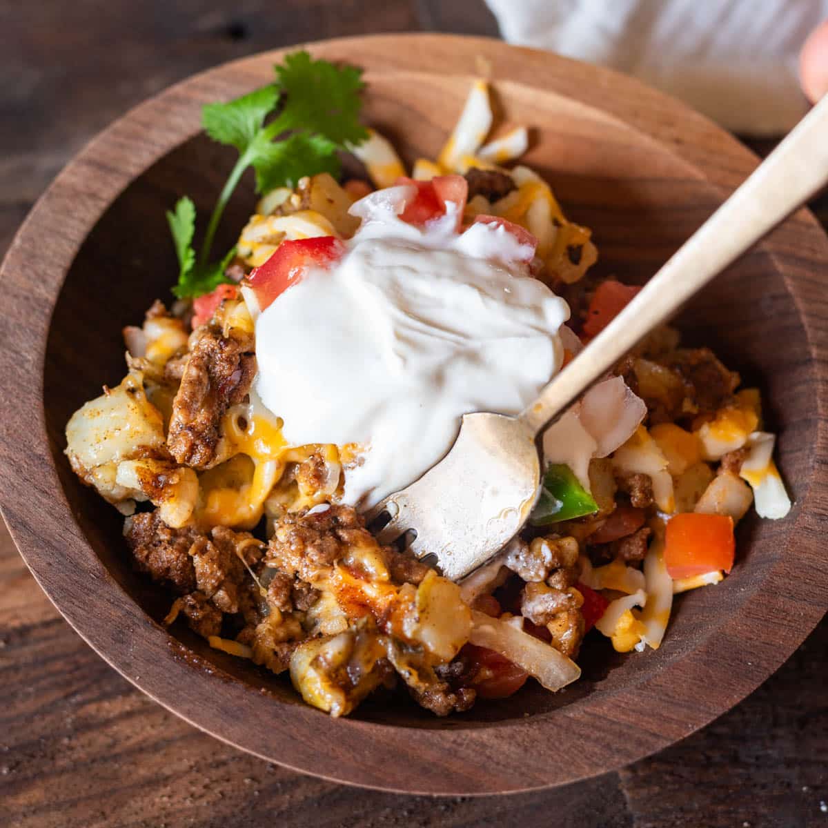 a bowl of mexican potatoes with taco toppings