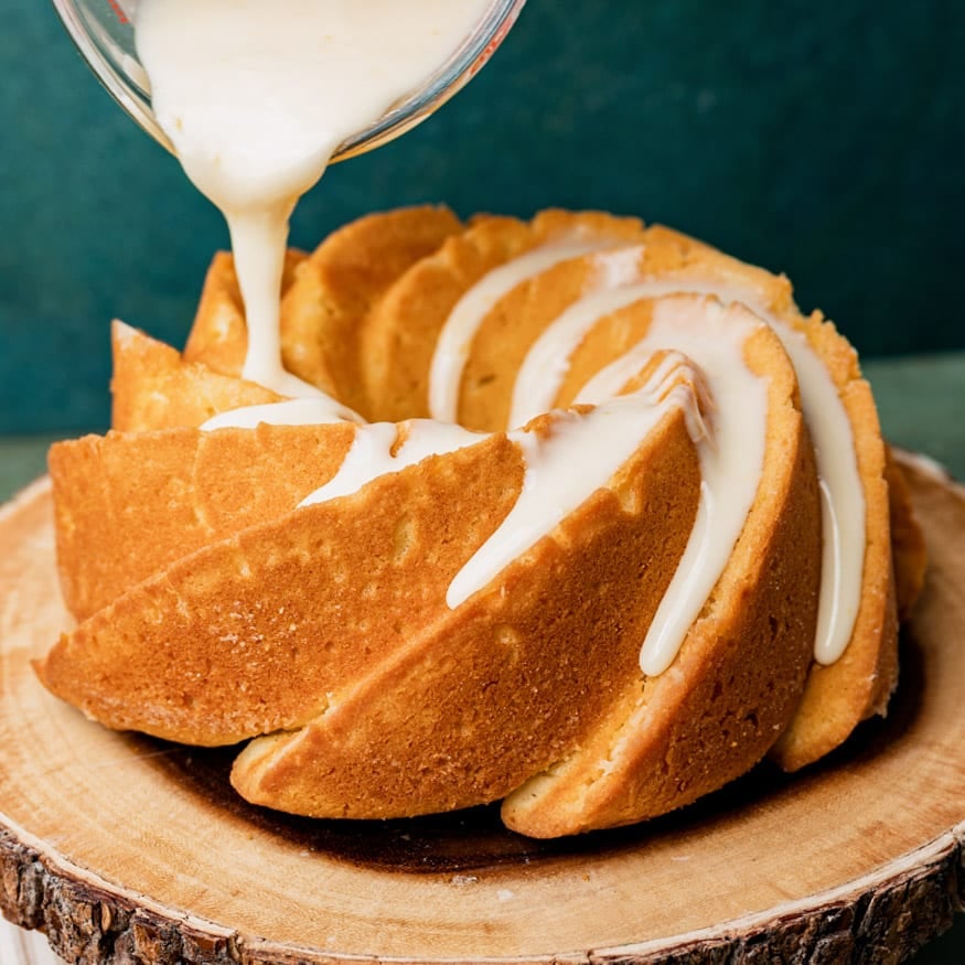 glaze pouring over a pound cake