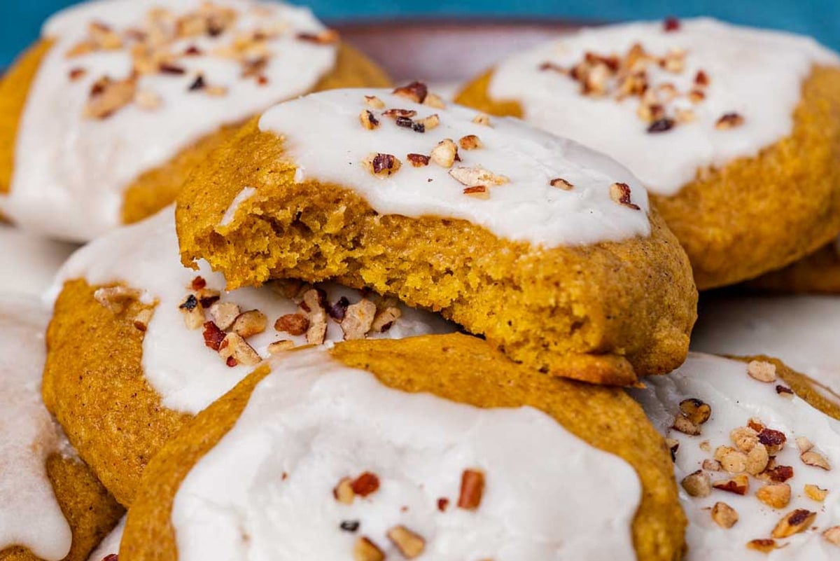 pumpkin cookies with icing on a plate